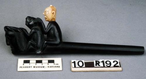 Argillite pipe in European style; head of human figure carved from walrus ivory