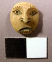 Buttons in form of human head-incised eyes, mouth, tattoo?