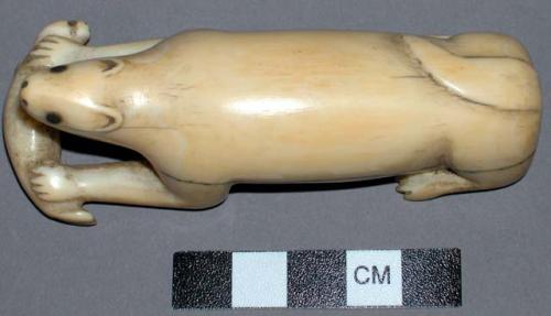 Ivory carving of a polar bear eating a seal