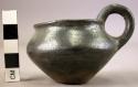 Ancient vessel; small cup with handle, black ware