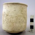 Ceramic cup, undecorated white ware, cylindrical, flared chipped rim