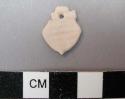 Piece of carved shell with single perforation at one end. 1.7 x 1.3 cm.