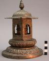 Prayer cylinder within pagoda-like throne on double lotus base