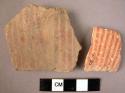 2 potsherds - painted design in thin red parallel lines