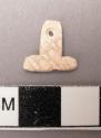 Piece of carved cardium shell(?) with perforation. 1.2 x 1.25 cm.