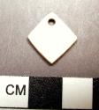 Piece of carved shell--square-shaped with perforation in one corner. 1.2 x 1.2
