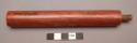 Portion of catlinite pipe. Tubular shape; sinew-wrapped wood at one end