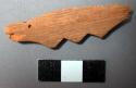 Ornament, carved wood fragment, 3 points at edge, insect bore holes
