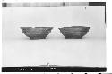 Two black ring stand bowls. Left: Diam 21.8, Ht. 8, Diam stand 10.6 cm. Lip roun