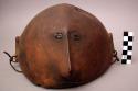 Wooden headdress or dish - carved face with metal for eyes and mouth +