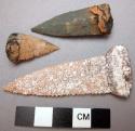 Projectile point, chipped stone, serrated eges, resinous residue at bases