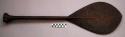 Paddle, carved wood, ovate blade, flared knob, geometric pattern, chipped