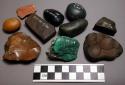 Worked stones, some polished or chipped, 1 sparkly green, incised ceramic