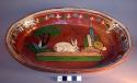 Flat-bottomed dish. buff clay, red-brown glaze with polychrome design