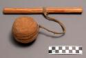 Fir wood knot ball and "cross" stick. Stick is attached to ball with a thong.