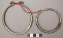 2 large crescent bracelets of white metal; Brass bracelets