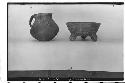 Shoe shaped pot & tripod bowl. Shoe shaped pot: lip diam 11.8, Ht. 16 cm. Black,