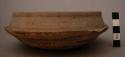 Bowl, rounded base and body, ridged, insloping rim, chipped, abraded