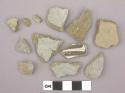 Ceramic sherds, gray or brown one side, one sherd has black designs on white
