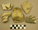 Body sherds, some handle remnants, black designs on white