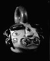 Stirrup vessel, spout missing, human head with fangs
