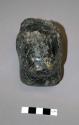 Ground stone sculpture, carved human head, chipped, greenstone