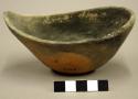 Boat-shaped scoop; rounded base, chipped rim, otherwise intact - salt smudged -
