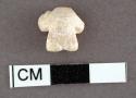 Fragment of carved glycymeris shell. 1.1 x 1 cm.