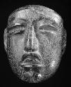 incised green stone mask