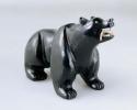 Effigy of a bear carved out of jet holding a fish in its mouth, abalone shell us