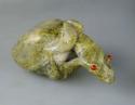 Effigy of a frog on a rock, serpentine with coral eyes, 12.7 x 7.9 cm.