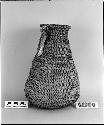 Bottle-shaped basket from unknown collection. Coiled, three-rod foundation, non-interlocking stitches.