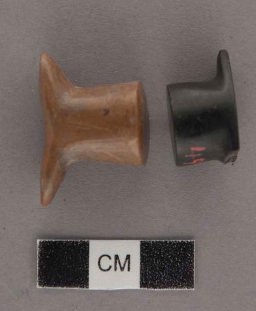 Ground stone; 2 ornaments - labret in form; portion missing on one, small losses