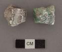 Two fragments of browninsh-green gray-green jade tubular beads with hieroglyphs