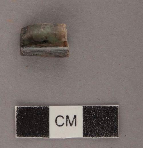 Ground stone ornament fragments, part of tubular bead, polished.