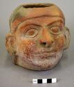 Ceramic vase, human effigy, molded face,   1 perforation in base,