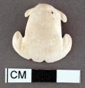 Glycymeris shell woth perforation in umbo, carved. 2.3 x 2.4 cm.