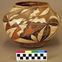 Pottery olla. Globular, red ware, brown, orange and red designs on white slip.