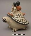 Storyteller figure; open-mouthed turtle with two children on its back, sitting back-to-back