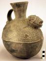 Ceramic vase, flaring rim, strap handle, animal effigy, molded, irregular shaped