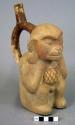 Ceramic bottle, stirrup spout, mended, animal effigy, monkey, molded face & arms