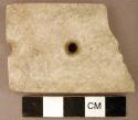 Ground stone, gorget fragment, flat and rectangular, three perforations, possibly reworked at one end