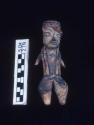 Clay figurine, type "D-1",  coffee-colored clay  with remains of red and yellow