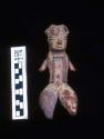 Clay figurine, type "D-1",  light coffee-colored clay  with remains of red and y