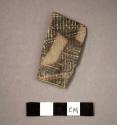 Ceramic body sherd, rectangular in shape, black painted and incised designs on exterior