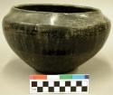Pottery bowl. Flat base, sharp recurved rim, polished black ware. 5.5" (height