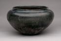 Large pottery storage jar. Small flat base, large orifice, short straight rim,