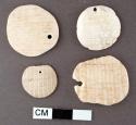 Carved shell disks with perforations--cardium shell? largest: 2.7 x 2.3 cm., sm