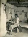 Hopi man weaving a sash