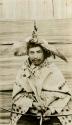 Thompson River Indian man "Kali'taa" in costume, including a headdress of loon skin